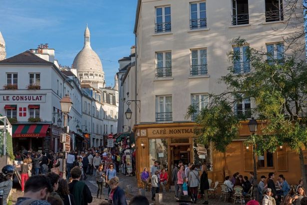 Paris, Montmartre, 18th arrondissement, rue Norvins, cafe Montmartre and street leading to the Sacré-Coeur. (Photo by: Gilles Targat/Photo 12/Universal Images Group via Getty Images)