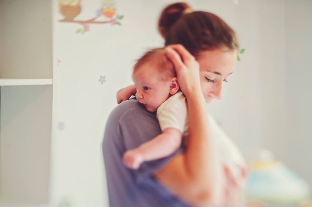 Mother holding her baby daughter