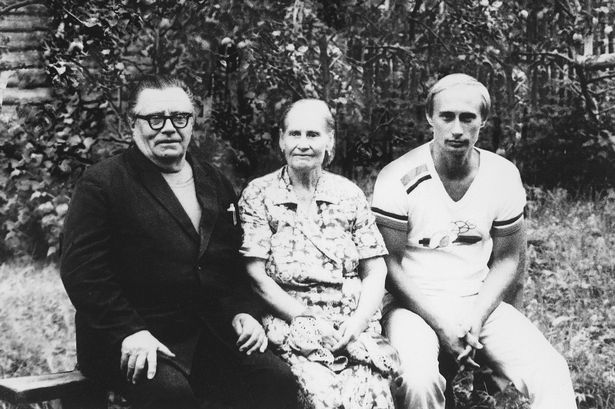 Vladimir Putin pictured with his parents Vladimir and Maria