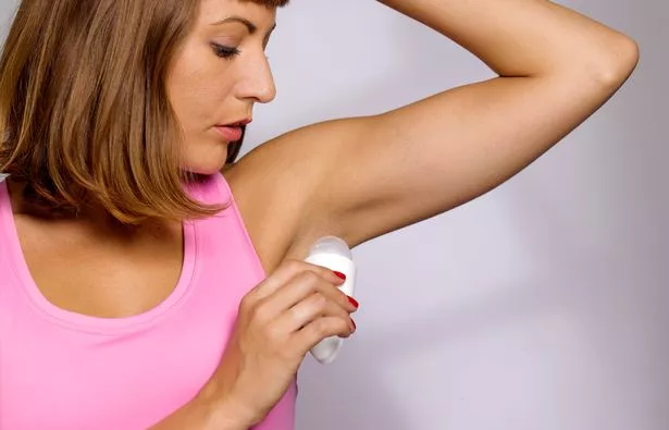 Person putting on deodorant
