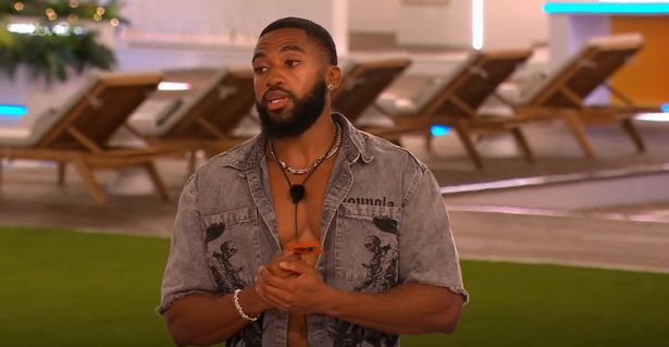 Remell Mullins stood in a grey jacket in the Love Island villa.