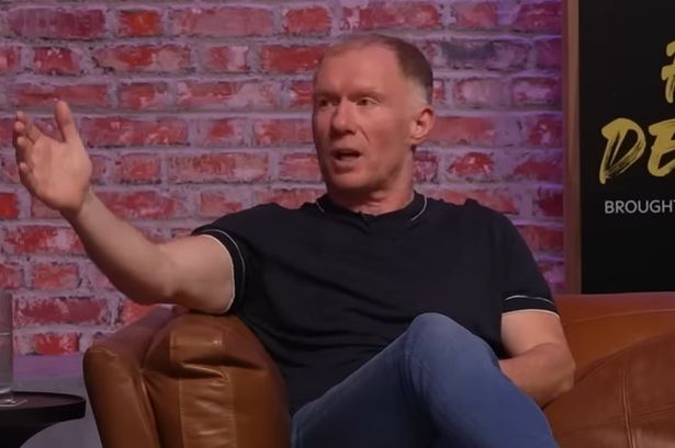 Paul Scholes speaking in an interview while sitting on a brown sofa