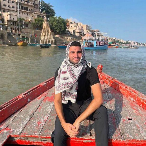 Image of Cameron on a boat during his travels