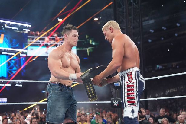EAST RUTHERFORD, NEW JERSEY - AUGUST 03: John Cena hands over the Undisputed WWE Championship title to Cody Rhodes during SummerSlam at MetLife Stadium on August 3, 2025 in East Rutherford, New Jersey. (Photo by Rich Freeda/WWE via Getty Images)