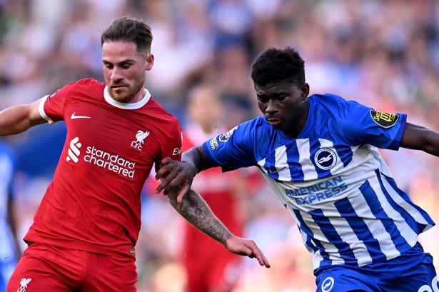 Alexis Mac Allister of Liverpool competing with Carlos Baleba of Brighton and Hove Albion during the Premier League match between Brighton & Hove Albion and Liverpool