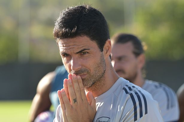 Mikel Arteta clasps his hands together and looks on