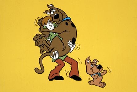 Shaggy holding Scooby-Doo in his arms and Scrappy-Doo at his feet. 
