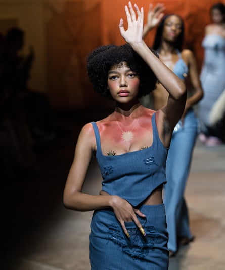 A model walks the runway with faux tan-lines. 