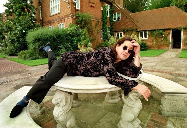 Ozzy poses in the grounds of his Buckinghamshire gardens