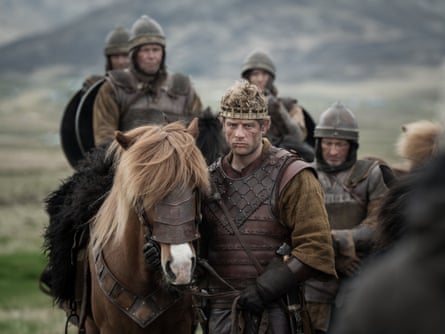 James Norton leading a horse, crown on hid head, surrounded by soldiers in King & Conqueror