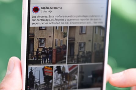A person shows Facebook posts from Union del Barrio about an Ice raid in LA in San Diego, California.