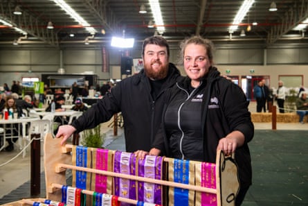 Two people stand next to a display of ribbons