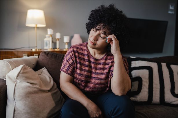 Photo of mature woman at home, feeling sad