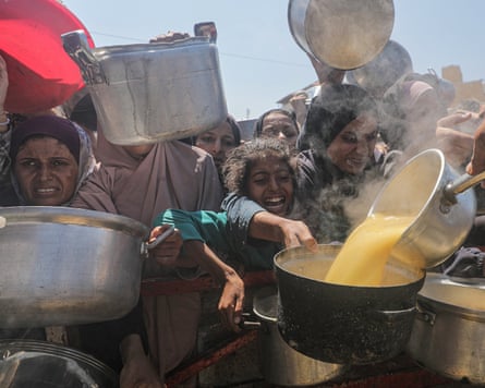 Displaced Palestinians collect food aid in Gaza City