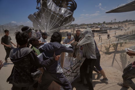 Palestinians gather around an airdropped pallet