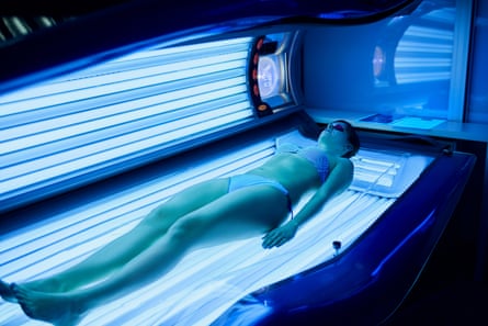 A woman in a sunbed.