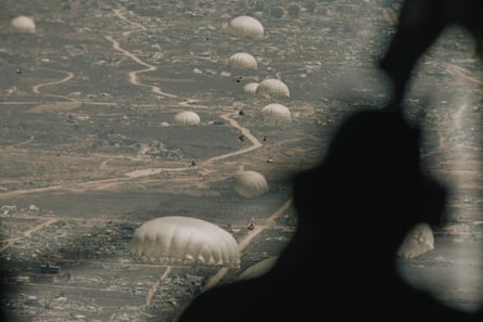 Aid floats towards the ground on parachutes