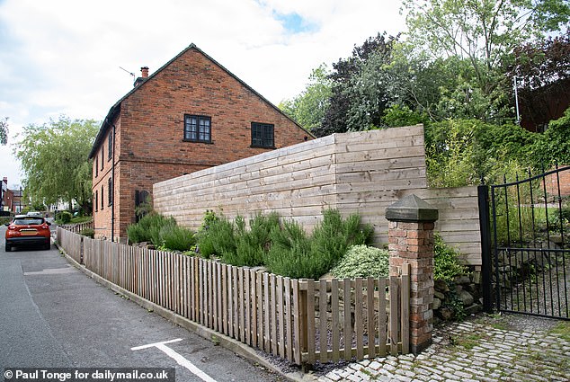 Mr Hubbard spent thousands of pounds clearing the garden and putting up a standard, eight-foot-high fence to give his family some privacy and stop the littering