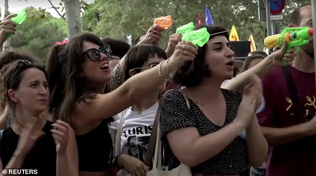 Protestors squirted water guns at tourists eating in popular spots in the city