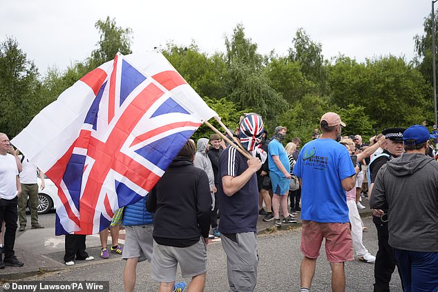 Rioters outside the Holiday Inn Express in Rotherham, kicking off another day of chaos