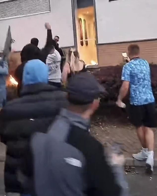People were seen cheering as thugs threw flames into the hotel's stairwell