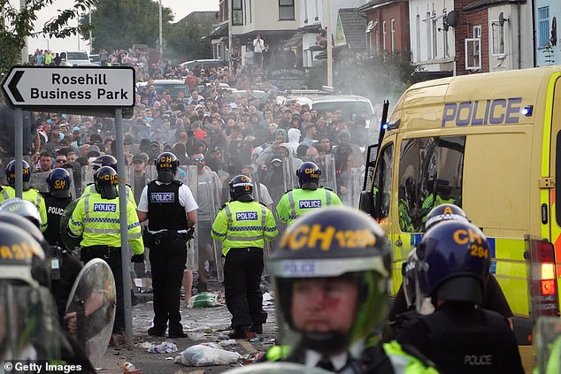Riot police hold back protesters after disorder broke out in Southport on July 30, 2024 - a day after the knife attack