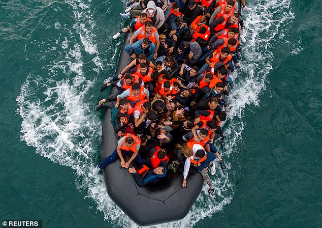 More than 25,000 migrants have now arrived in the UK in small boats this year, the earliest that this milestone has been reached (Pictured: packed dinghy in the Channel last August)