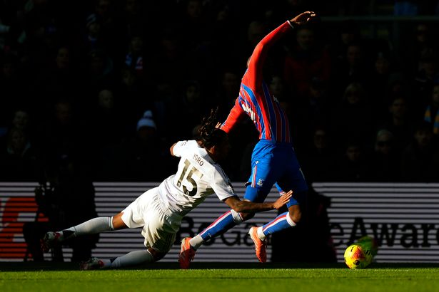 Manchester United's Leny Yoro (left) fouls Crystal Palace's Jean-Philippe Mateta which leads to a penalty.