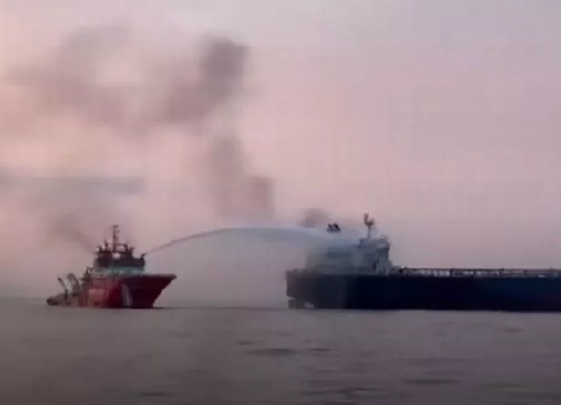 Emergency rescue boat puts out the fire on a tanker