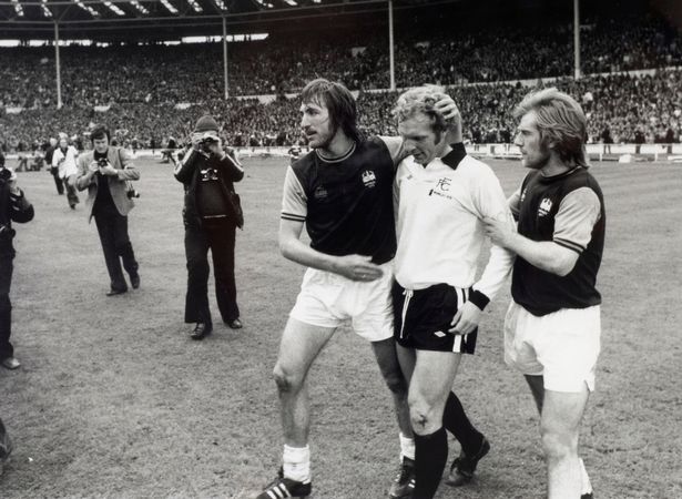 West Ham captain Billy Bonds consoles his great mate Bobby Moore who was playing for Fulham after 1975 FA Cup final