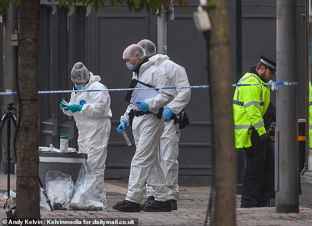 Police forensic officers conduct searches in the streets of Altrincham after pair were stabbed