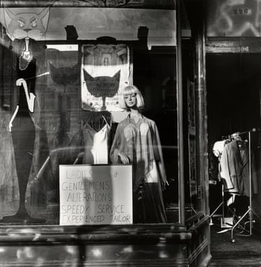 a black and white photo of a mannequin in a shop window