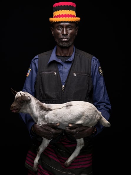 Nakwani Etirae, pastoralist turned farmer, pastor and shop owner. Pictured holding a young goat
