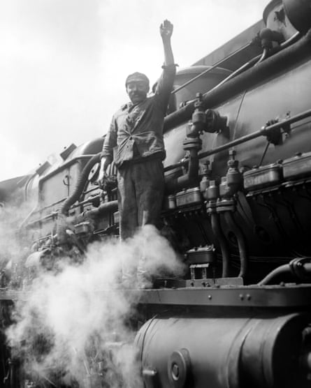 French train driver on steam locomotive wearing work jacket