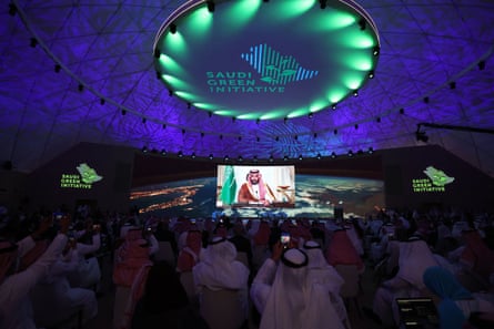 Mohammed bin Salman’s image on a screen in a large conference hall