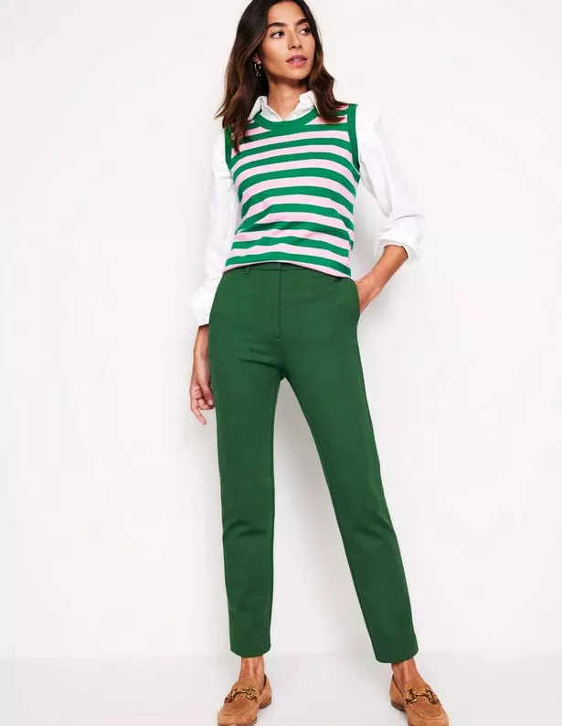 Person wearing green trousers and a striped top