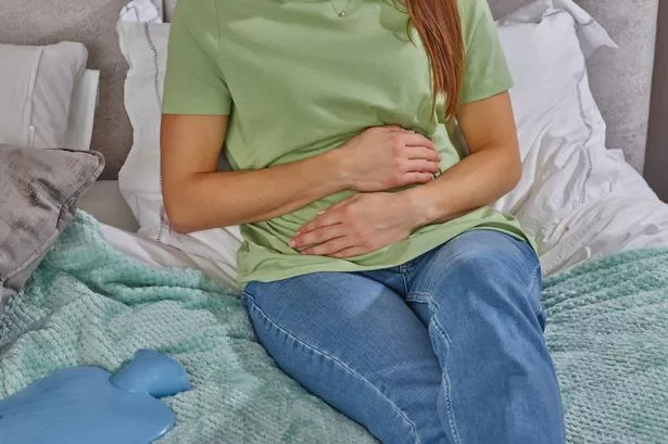 Woman clutching stomach
