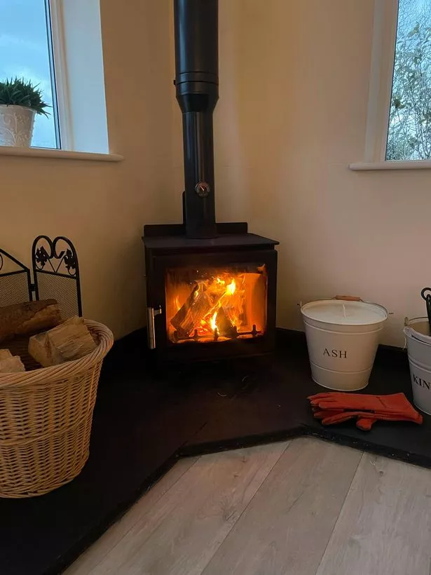 a wood burner in the corner of a room