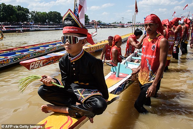 Rayyan Arkan Dikha (L), 11, went viral for his calm dance on the bow of a traditional longboa in Indonesia and was described with the word 'aura farming'