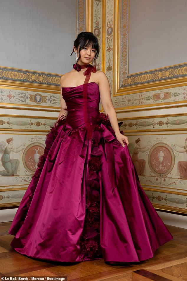 Alice Wang is the daughter of Stella Li, the CEO of BYD Americas and Chuanfu Wang, founder of BYD - the company behind the world's top electric car company. She chose to wear a ruby red Vera Wang number to Le Bal