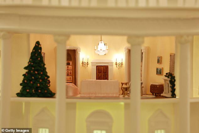 The Gingerbread White House is displayed in the State Dining Room