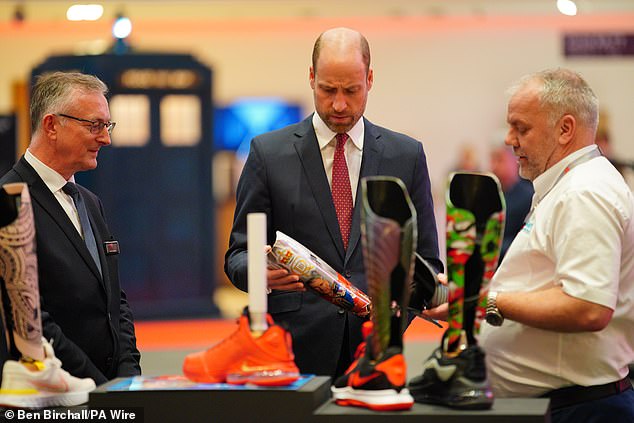 The royal (picture, centre) is seen looking at prosthetics during a visit to the Wales Investment Summit on Monday