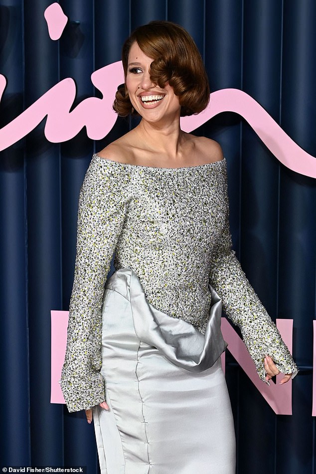 Raye beamed as she arrived for the annual awards in her showstopping look