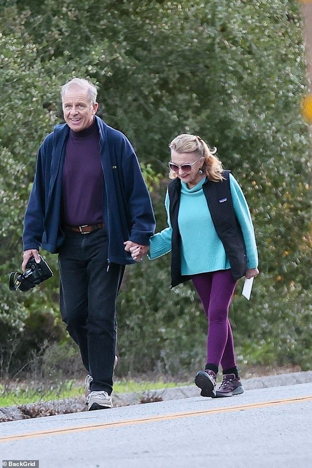 Caulfield was clad in a purple turtleneck, black jeans, and blue sweater, while his lady love opted for violet leggings, a blue sweater, and Patagonia vest