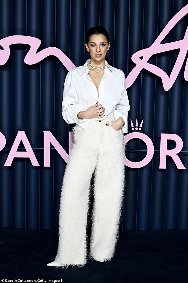 The actress opted for all-white, which was a stark contrast with the event's blue carpet