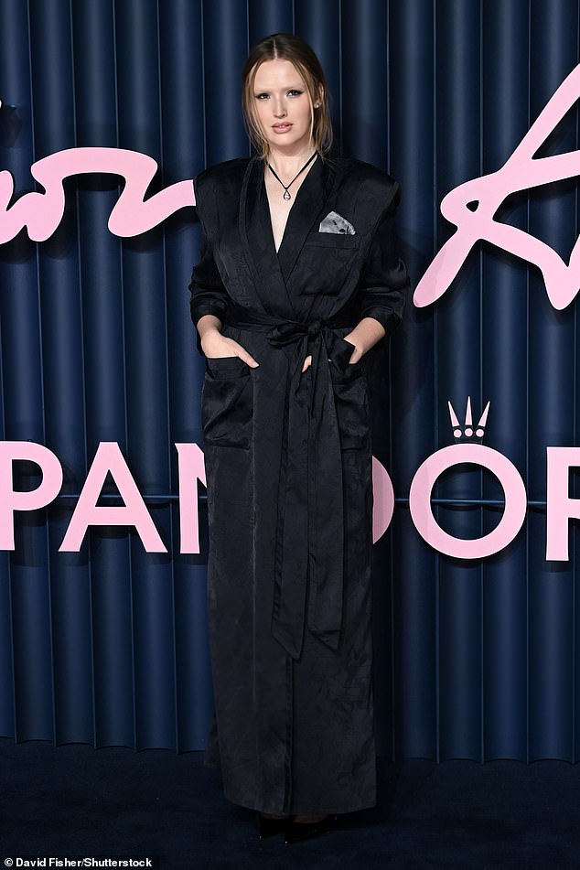 Dynasty star Maddison Brown put on a chic display in a simple black trench coat