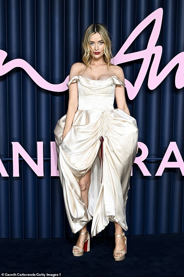 Laura Whitmore graced the blue carpet in a white satin gown with a voluminous skirt