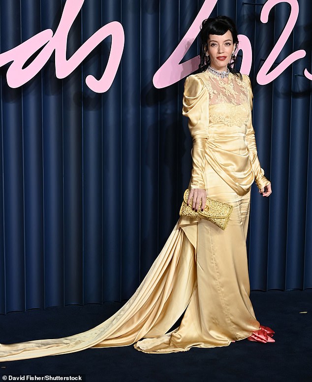 The singer looked sensational in a bold vintage inspired gold gown which featured sophisticated lace detailing and a dramatic train