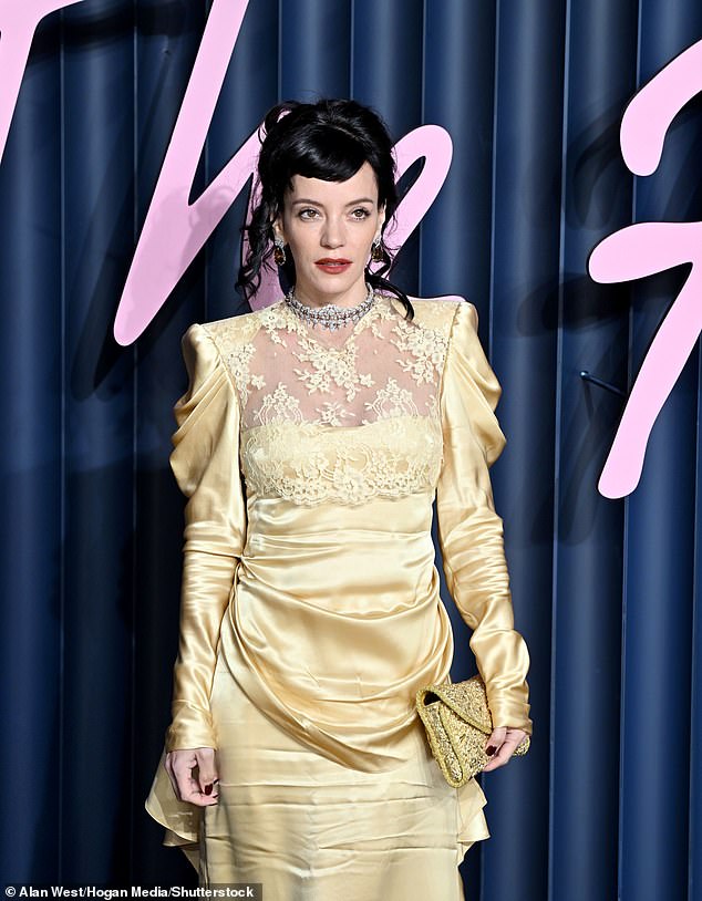 Lily's look also boasted draping and shoulder pads while adding extra sparkle with a diamond choker and pendant earrings