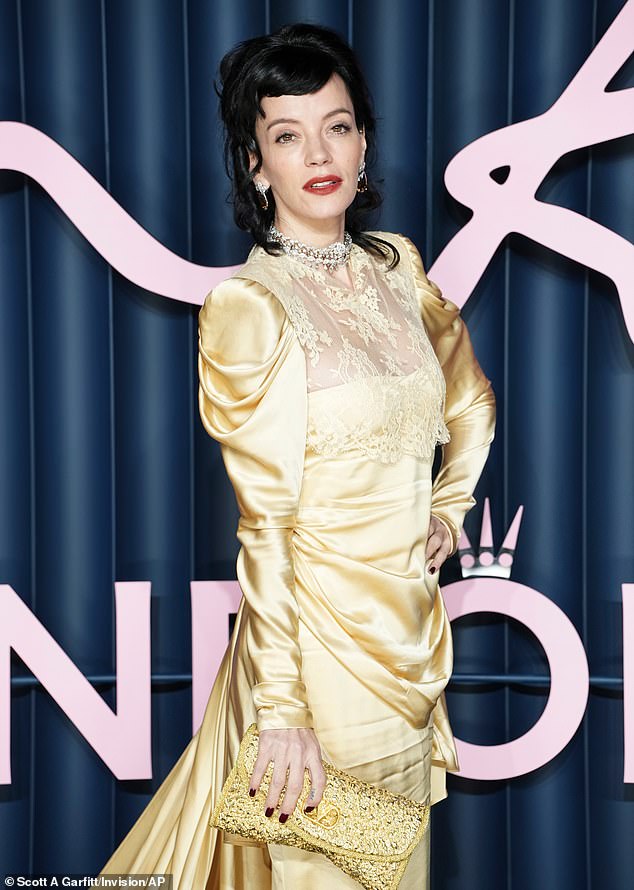 Styling her raven tresses into curls, the West End Girl hitmaker completed the look with satin bow heels and a sparkly clutch